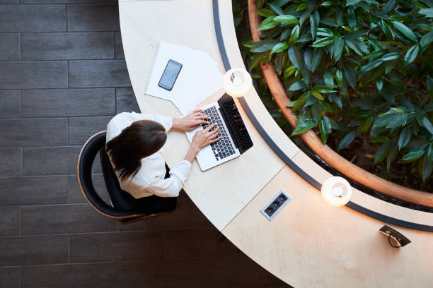istock Young woman working on her laptop in a library 1268902119