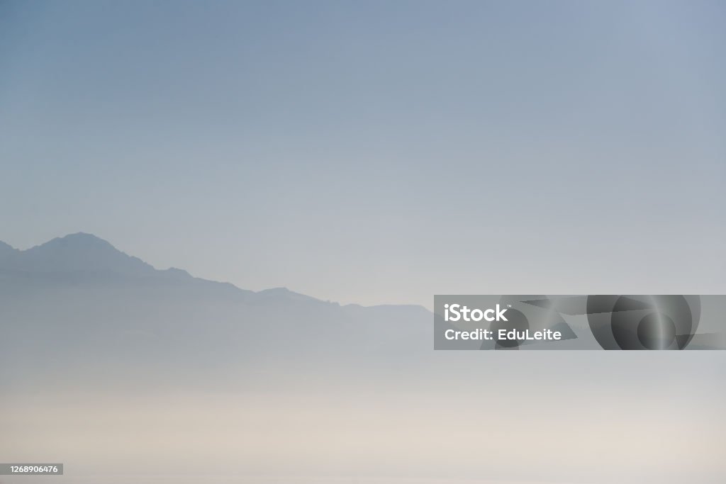 Foggy morning Foggy morning with mountains in background Atmospheric Mood Stock Photo