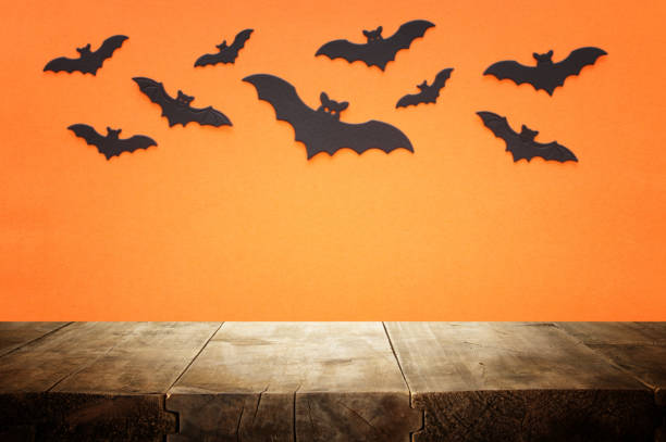 istock holidays concept of Halloween. Empty rustic table in front of bats background. Ready for product display montage 1268906806
