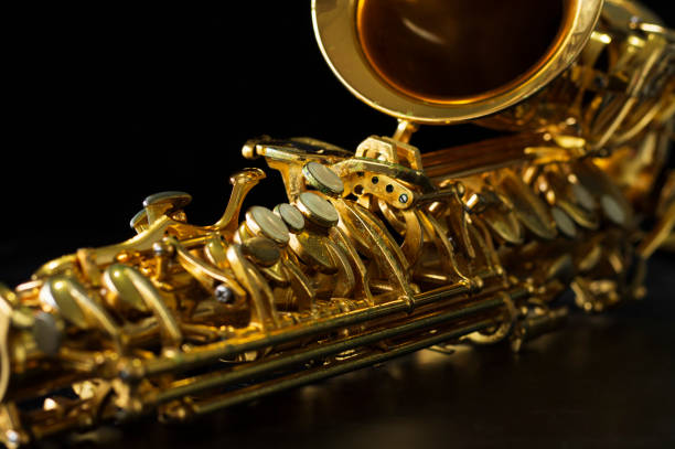 istock close up on alto saxophone details, black background, 1268907930