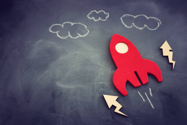 istock education or innovation concept. Wooden rocket over blackboard background. top view 1268908281