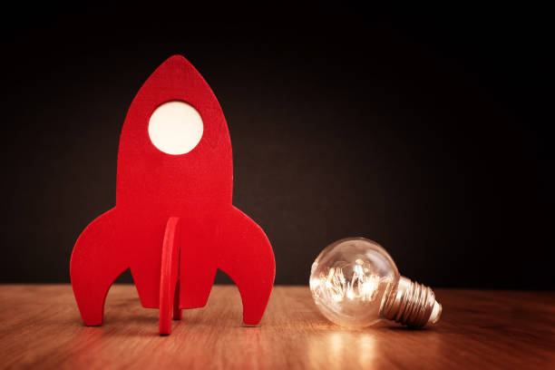 istock education or innovation concept. Wooden rocket over blackboard background. top view 1268908283