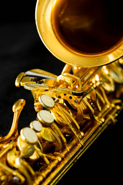 istock close up on alto saxophone details, black background, 1268908339