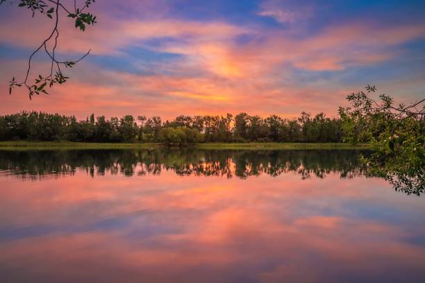istock Sunrise Sky Reflecting In A Park Lake 1268908560