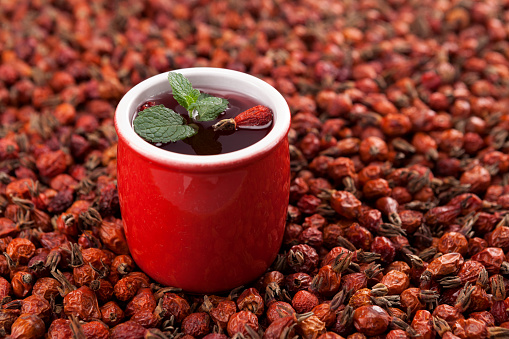 Vitamin tea or tincture from dried rosehip berries. Antioxidant, a tasty and healthy source of vitamin C. It is used in alternative medicine. Selective focus, horizontal orientation.
