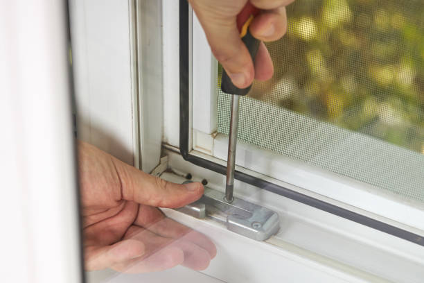 istock handyman adjusting white pvc plastic window indoors. worker using screwdriver to repair upvc window. homework maintenance 1268917338