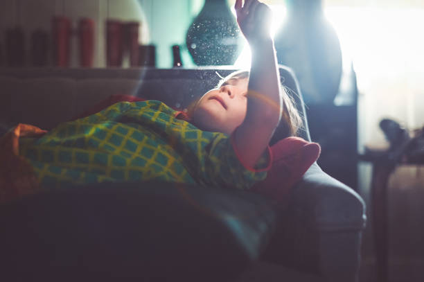 istock Child at home with dust particles 1268921119