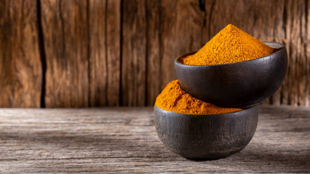 istock Turmeric powder in bowl 1268925501