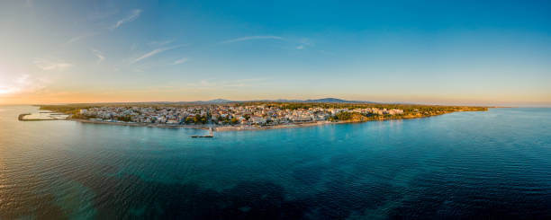 Panoramic aerial photo of the town and port of Nea Kallikrateia, Thessaloniki, Halkidiki Peninsula at summer at dusk Panoramic aerial photo of the town and port of Nea Kallikrateia, Thessaloniki, Halkidiki Peninsula at summer at dusk halkidiki beach stock pictures, royalty-free photos & images