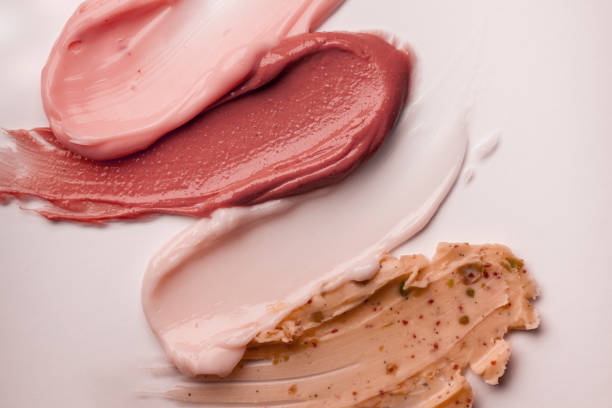 Multi-colored blue mint green beige gray pink yellow red brown olive clay cream mask sample textured foundation isolated on multi-colored background