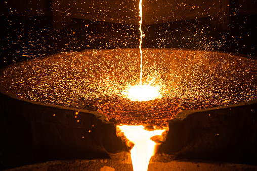 Pouring liquid metal from arc furnace