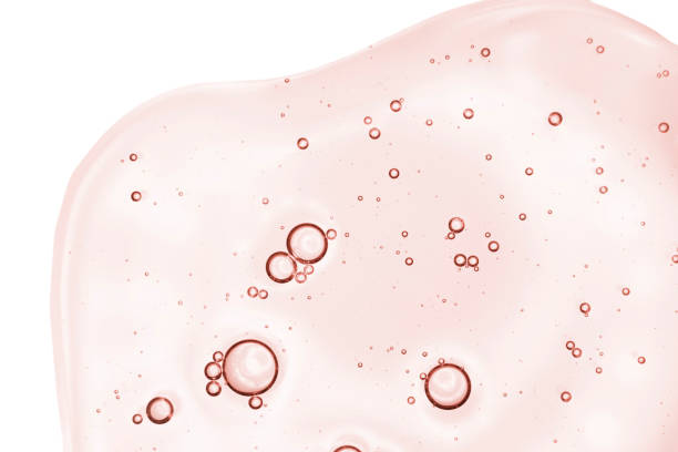 Red pink transparent cosmetic cream gel retinol serum texture with bubbles isolated on white background Red pink transparent cosmetic cream gel retinol serum texture with bubbles isolated on white background blood serum photos stock pictures, royalty-free photos & images