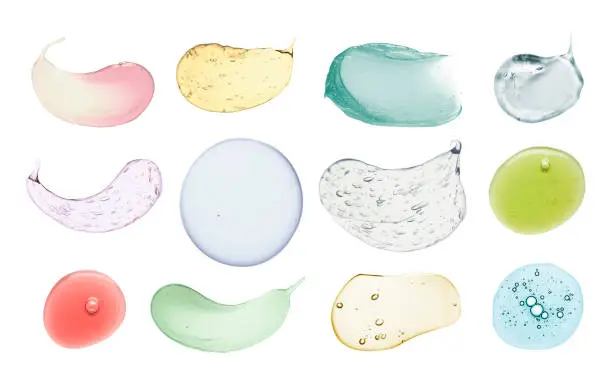 Photo of Blue gray green aloe vera pink transparent cosmetic cream gel retinol serum texture with bubbles isolated on white and multi-colored background