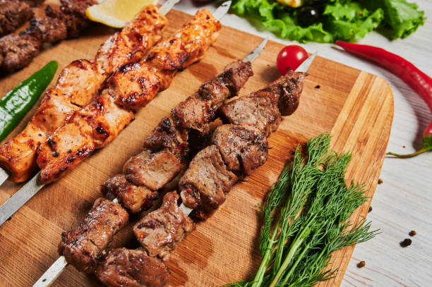 istock lamb shish kebab with vegetables on a wooden Board. 1268932582
