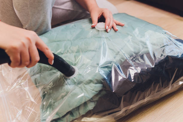 istock Space saver saving seal bag sucking air out , vacuum clothing storage compressed package. 1268932663
