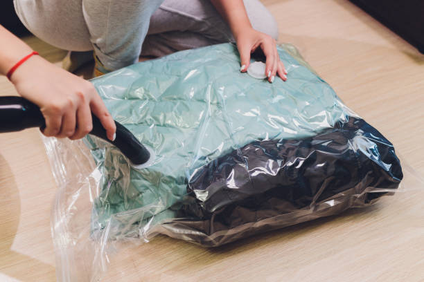 istock Space saver saving seal bag sucking air out , vacuum clothing storage compressed package. 1268932684