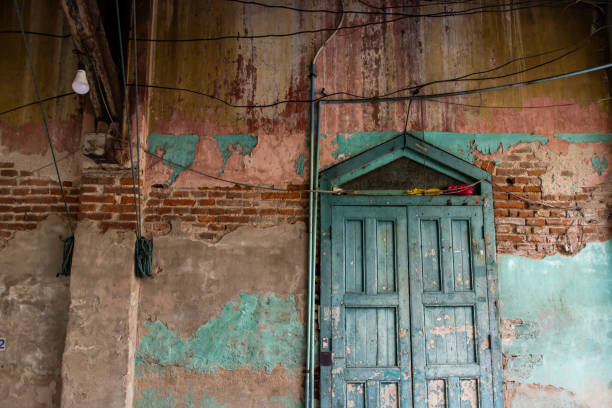 istock Old wood vintage door on the old wall with visible bricks texture was left to deteriorate over time. 1268932892