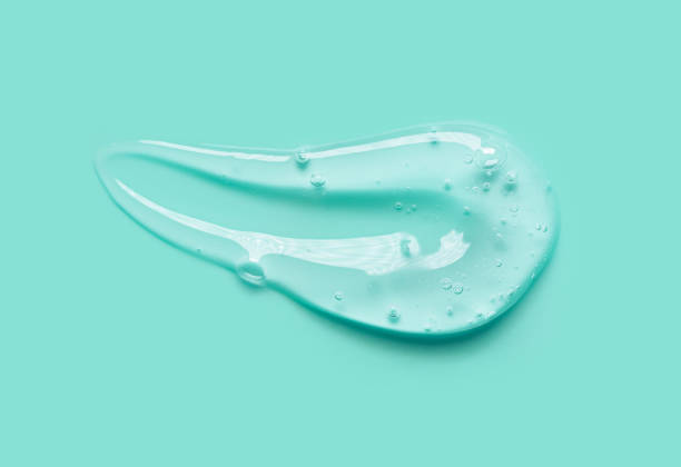 Blue gray green aloe vera pink transparent cosmetic cream gel retinol serum texture with bubbles isolated on green background Blue grey green aloe vera pink transparent cosmetic cream gel retinol serum texture with bubbles isolated on green background shower gel stock pictures, royalty-free photos & images