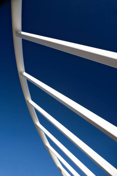 istock Close up white metal bars against a blue sky 1268942653