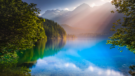 Idyllic Lake Tovel reflection, long exposure at sunrise – Trentino, Dolomites – Italy