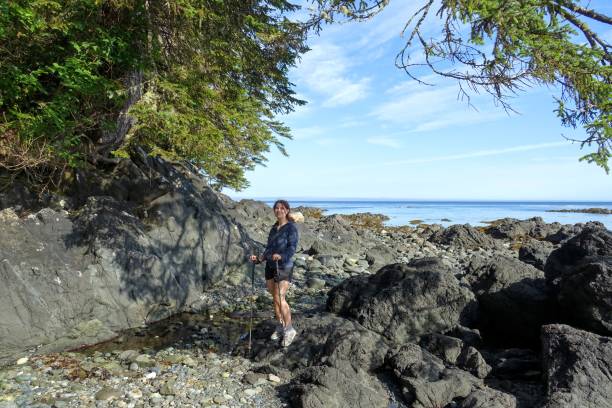 istock A female hiker exploring the sandy beaches of nels bight and experimental bight, surrounded by forest and the pacific ocean, along the beautiful cape scott trail on Northern Vancouver island 1268949134