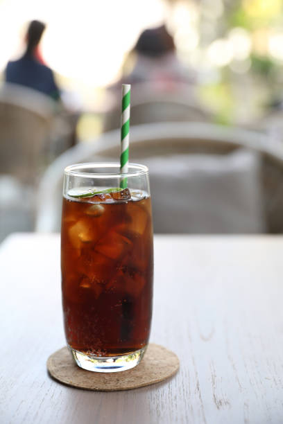 istock Cola close up on wood background 1268949873