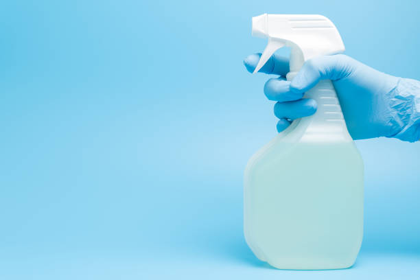istock Hand in glove holds disinfectant spray 1268950747