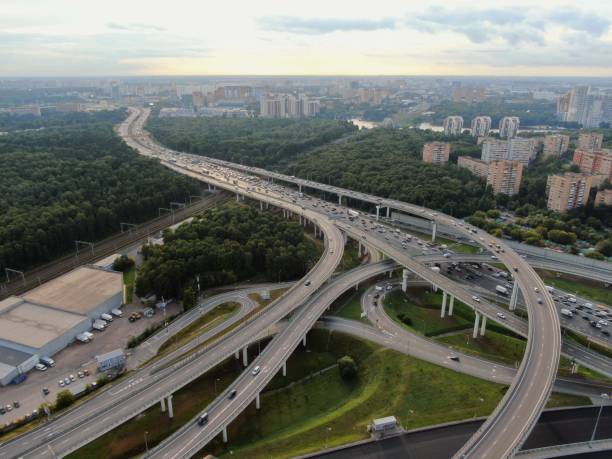 istock Aerial view flight over a multi-level transport interchange in Moscow at sunset. Traffic traffic on the highway in the city. cityscape from drone 1268951981