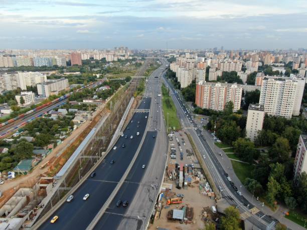 istock Aerial view flight over a multi-level transport interchange in Moscow at sunset. Traffic traffic on the highway in the city. cityscape from drone 1268952538