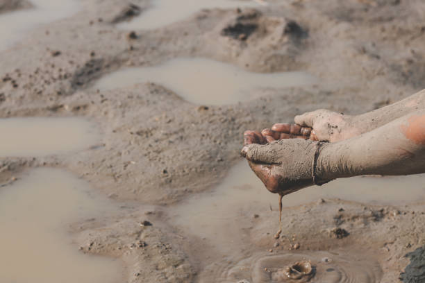 istock The little boy waiting for drinking water to live through this drought, Concept drought and crisis environment. 1268955413