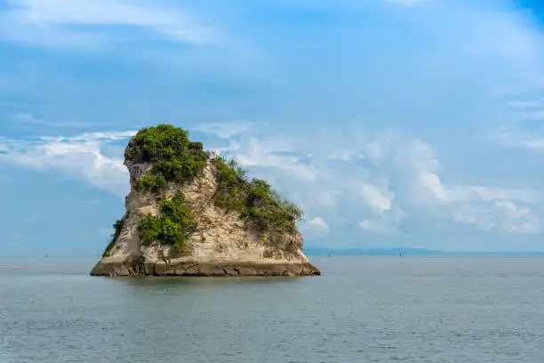 Large rock that emerges on a beach in Tumaco. Colombia.