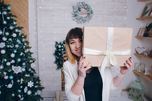 istock young girl keeps a Christmas Gift Box 1268958628