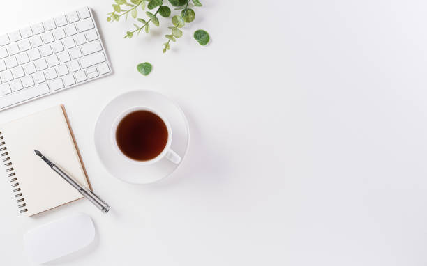 istock Flat lay, top view office table desk. Workspace with keyboard, office supplies, pencil and coffee cup with copy space on white background. 1268958778