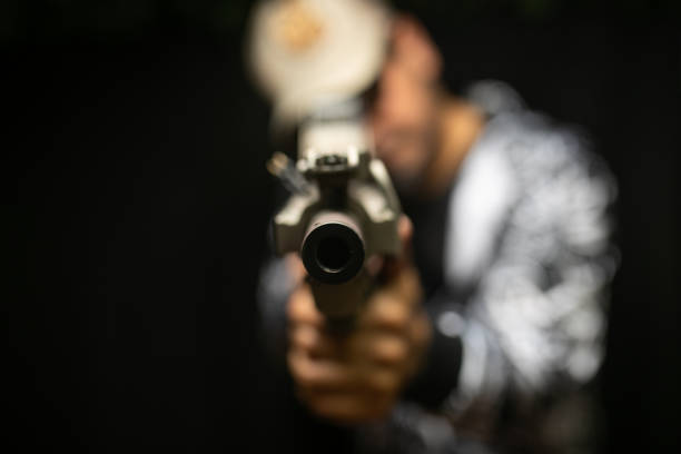 a man holds a gun in his hand