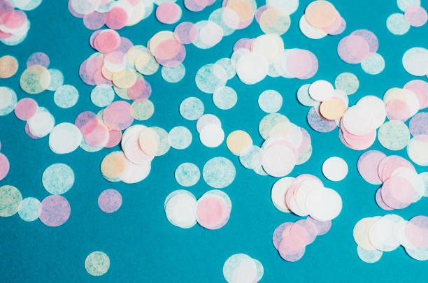 istock Turquoise background with many round multicolored confetti. 1268990600