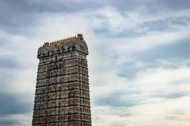 murdeshwar temple rajagopuram entrance with flat sky image is take at murdeshwar karnataka india at early morning. it is one of the tallest gopuram or temple entrance gate in the world.