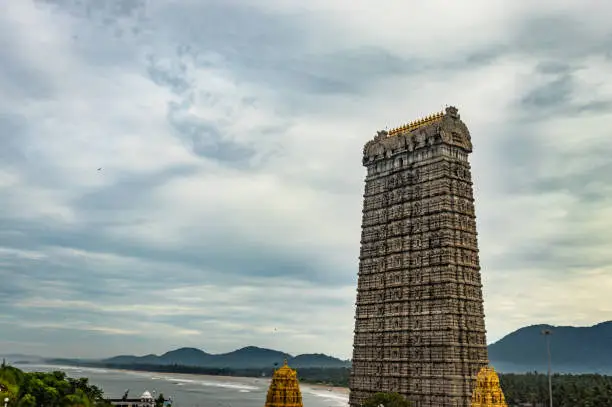murdeshwar temple rajagopuram entrance with flat sky image is take at murdeshwar karnataka india at early morning. it is one of the tallest gopuram or temple entrance gate in the world.