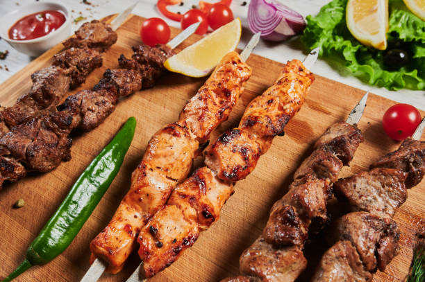 istock lamb shish kebab with vegetables on a wooden Board. 1268993186