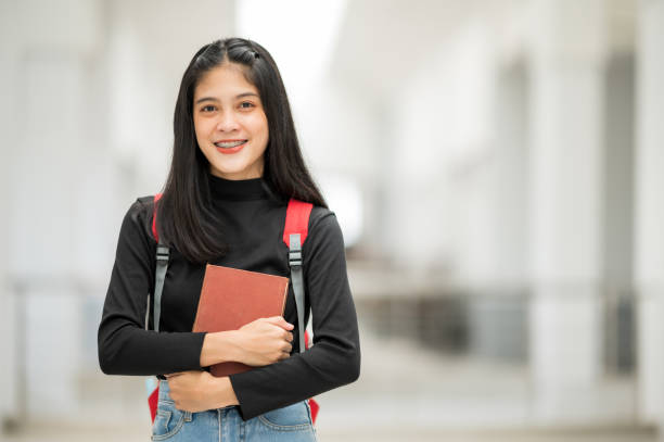 istock A female Asian college student smiled at the university and stared at the camera. 1268994653