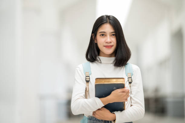 istock A female Asian college student smiled at the university and stared at the camera. 1268994857