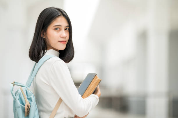 istock A female Asian college student smiled at the university and stared at the camera. 1268995180
