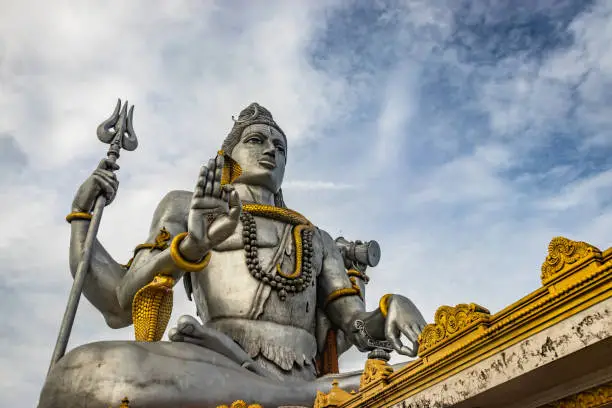 shiva statue isolated at murdeshwar temple close up shots from low angle image is take at murdeshwar karnataka india at early morning. it is one of the tallest shiva statue in the world.
