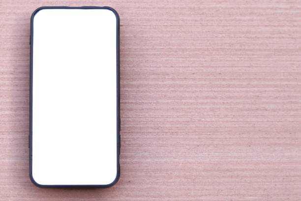 istock Black smartphone with white screen on wooden texture background 1268995894