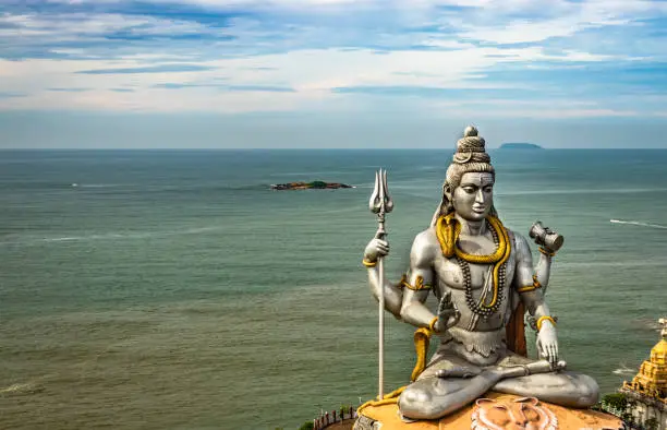 shiva statue isolated at murdeshwar temple aerial shots with arabian sea in the backdrop image is take at murdeshwar karnataka india. it is one of the tallest shiva statue in the world.
