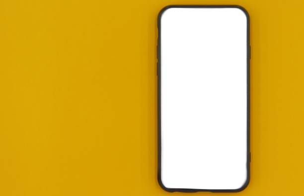 istock Black smartphone with white screen with yellow background 1268995959
