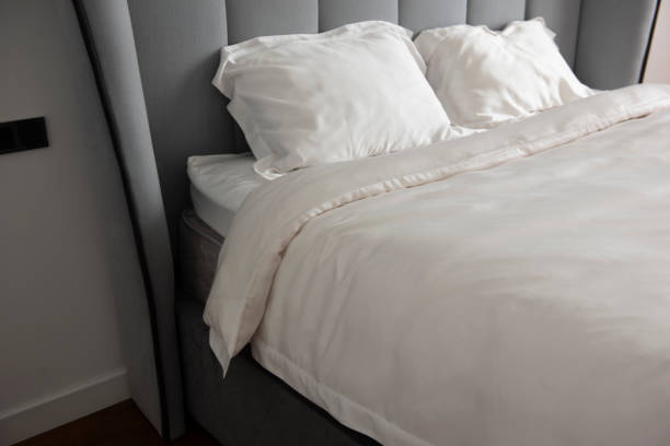 istock Beautiful bedding on a large bed in a king size bedroom 1268998382