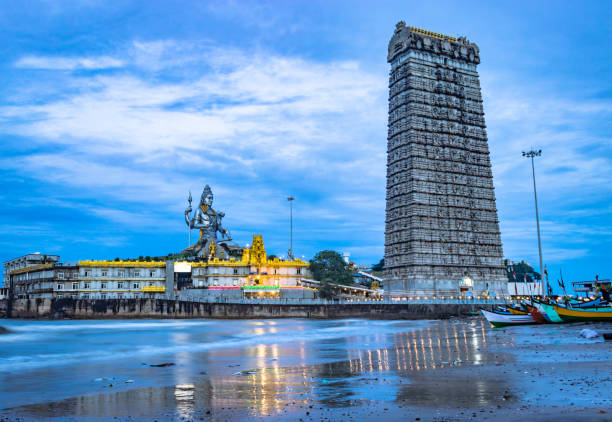 murdeshwar temple early morning view from a low angle with sea waves image is taken at murudeshwar karnataka india at early morning. it is the house of one of the tallest rajagopuram in the world.