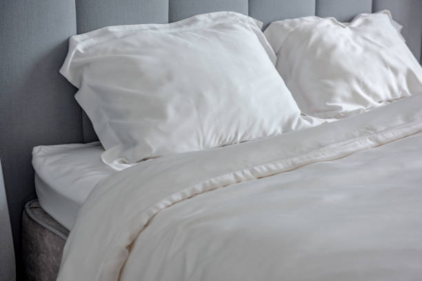 istock Beautiful bedding on a large bed in a king size bedroom 1268999465