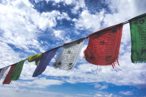 Tibetan prayer flags in the blue sky with clouds