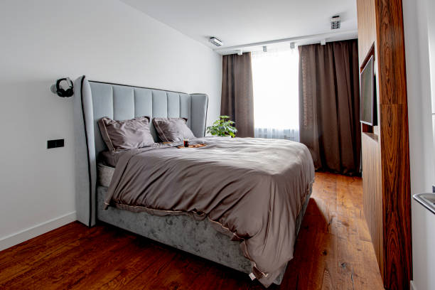 istock Beautiful bedding on a large bed in a king size bedroom 1269000998